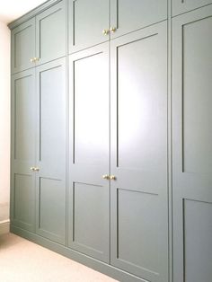 an empty room with green cabinets and white walls