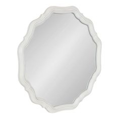 a white mirror with an oval frame