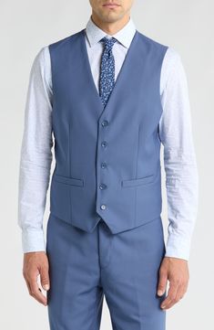 Bring understated elegance to the table in this three-piece suit crafted from rich fabric in a classic single-breasted silhouette. Jacket has notched lapels; chest welt pocket; front flap pockets Vest has front button closure; V-neck Pants have zip fly with button closure; front slant pockets; back button-welt pockets Jacket and vest are lined; trousers are lined to the knee 65% polyester, 35% viscose Dry clean Imported Each suit has a 6” drop, meaning that a size 38R jacket is paired with size Blue Semi-formal Suits With Flat Front, Blue Semi-formal Flat Front Suits, Blue Slim Fit Three-piece Suit With Single Button, Classic Blue Three-piece Suit With Single Button, Semi-formal Three-piece Suit With Suit Collar And Pockets, Elegant Business Casual Three-piece Suit With Pockets, Elegant Three-piece Suit With Pockets For Business Casual, Semi-formal Three-piece Suit With Pockets, Blue Slim Fit Three-piece Suit With Notch Lapel