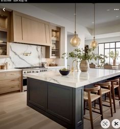 a kitchen with marble counter tops and wooden stools next to an island in the middle