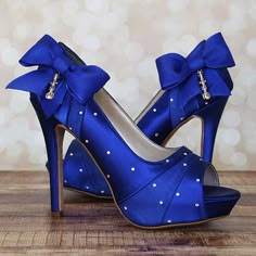 a pair of blue high heeled shoes with bows