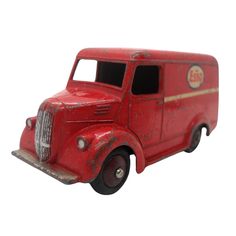 an old red toy fire truck on a white background