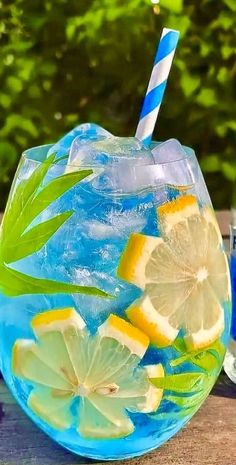 a glass filled with lemon and limeade on top of a wooden table