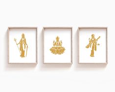 three framed artwork pieces on a white wall with gold foil designs in the middle and bottom