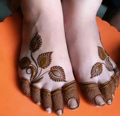 the feet are decorated with flowers and leaves