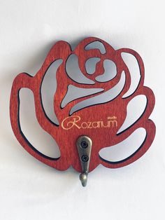 a wooden clock with the word roostum on it's face and an intricate rose design