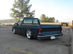 a blue pickup truck parked in a parking lot