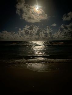 the moon is shining brightly over the ocean