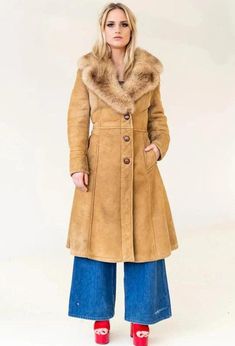 Discover timeless elegance with our Penny Lane Coat, a luxurious women's fur coat that perfectly blends vintage charm and modern style. This shearling coat features a genuine suede leather exterior and an original shearling lining, providing exceptional warmth and comfort. In a rich brown hue, this long coat evokes the iconic fashion of the 80s, offering a sophisticated trench coat silhouette. Inspired by traditional Afghan coats, it embraces a boho aesthetic perfect for winter. Crafted from hig Vintage Shearling Fur Coat With Faux Fur Trim, Vintage Long Coat In Faux Fur, Classic Sheepskin Coat With Faux Fur Trim, Classic Sheepskin Fur Coat With Faux Fur Trim, Cold Weather Long Fur Coat, Classic Long Faux Fur Coat, Vintage Faux Fur Coat For Cold Weather, Classic Sheepskin Fur Coat For Winter, Classic Fur Coat With Faux Fur Lining For Fall