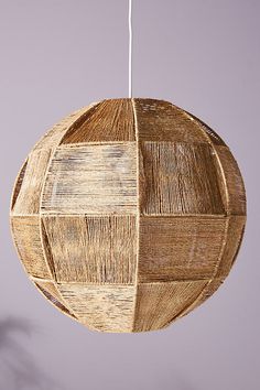 a round light fixture made out of woven material