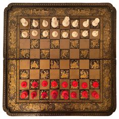 an old board game with red and white pieces