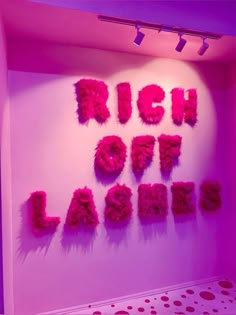 a pink room with the words rich out lager written in bright letters on it