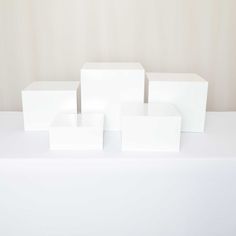 four white boxes sitting on top of a table