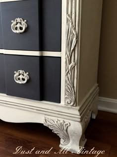 an old dresser has been painted black and white with silver details on the top drawers