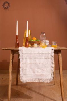 a table with candles and fruit on it