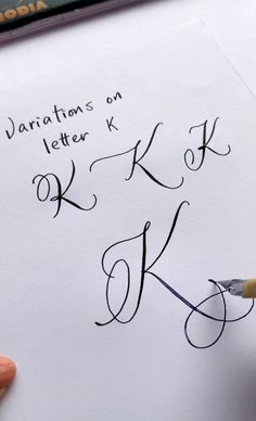 someone is writing letters on a piece of paper