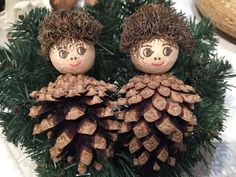 two small pine cones with faces on them