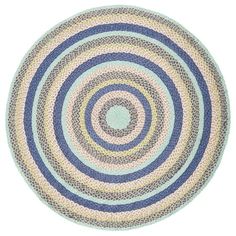 a circular rug with blue and pink circles on it, in the middle of a white background