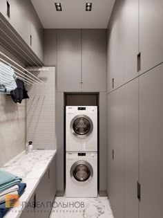 a washer and dryer in a small room with white counter tops on the floor