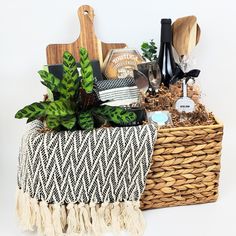 a basket filled with lots of different items next to a cutting board and potted plant