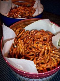 two buckets filled with food sitting on top of a table