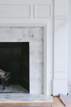 an empty fireplace with a wheelbarrow in the middle