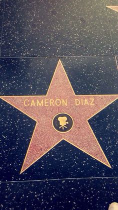 someone standing next to a star on the hollywood walk of fame