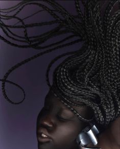 a woman with dreadlocks talking on a cell phone