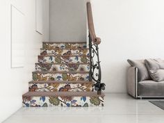 the stairs are decorated with flowers and birds on them, along with a gray couch