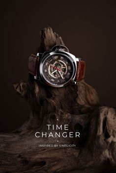 a watch sitting on top of a tree stump with the words time changer written below it