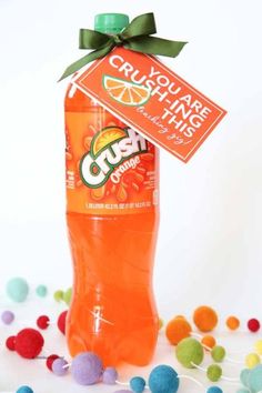 an orange crush soda bottle with gum balls around it