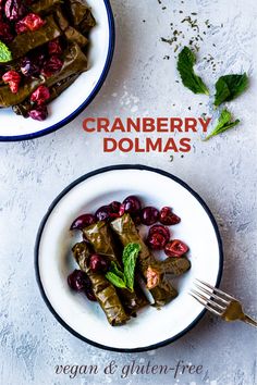 cranberry dolmas are served on white plates with mint garnish