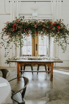 a table with flowers and greenery on it