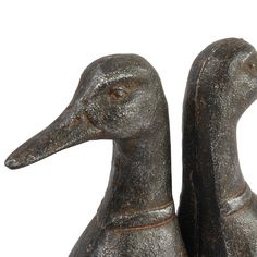 two metal ducks sitting next to each other