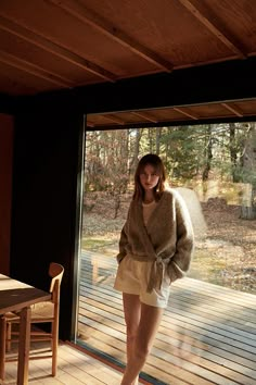 a woman standing in front of a sliding glass door