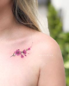 a woman's chest with pink flowers on it