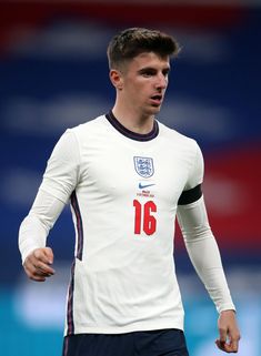 a young man in white jersey playing soccer