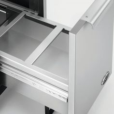 an open drawer on the side of a refrigerator