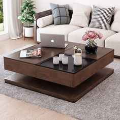 a coffee table with a laptop on it