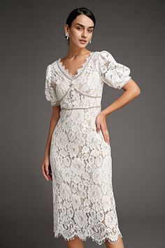 This lace crochet V-neckline midi dress will fill any of your little white dress needs, from your bridal shower to your after party. The textured lace overlay, accented with thick embroidery that outlines the lace’s blooms. Also features puff sleeves and delicate scalloped eyelash lace hem. The rhinestone trim and buttons adds an extra glitz and glam. No Stretch Medium Weight Size runs small,recommend one size up Fabric: 100% Polyester,Lining: 100% Polyester Model is 174cm/5'7" tall, 81cm/32" bust, 61cm/24" waist and 90cm/35" hip and wears a size S. Care Instruction: Hand Wash, Do not bleach, Dry flat in shade, Iron cool (max 110â„?, Dry clean, tetrachloroethylene(PCE) only.Please note: The images represent actual product though color of the image and product may slightly differ. This item Gown Shapes, Wedding Guest Dresses Formal, Midi Dress Wedding, Thick Embroidery, Modest Midi Dress, Vintage Dress Design, Dresses Wedding Guest, Little White Dress, Cap Dress