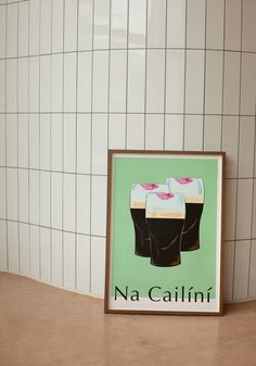 a beer poster is on the counter next to a wall with white tiles and a green background