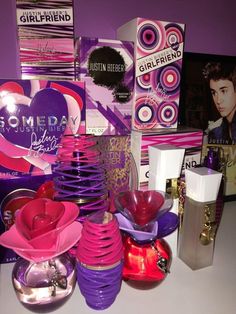 a table topped with lots of purple and pink items