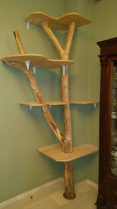 a wooden tree shelf in the corner of a room