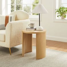 a living room with a chair, table and lamp