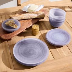 purple plates and bread on a wooden table