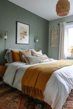 a bedroom with green walls and white bedding, yellow throw blanket on top of the bed