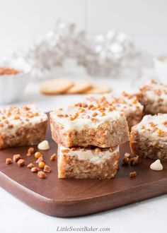 several pieces of cake sitting on top of a cutting board next to some crackers