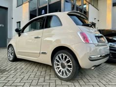 a white car parked in front of a building