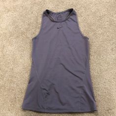 A Brand New Tank Top From Nike, Size Xs. It’s A Gray Tank Top From Their Dri-Fit Collection With Great Breathability. It Has A High Neck With The Nike Logo Across The Upper Chest And A Racer Back. Nike Gray Stretch Top, Nike Gray Gym Tops, Nike Gray Summer Tops, Nike Summer Gray Tops, Gray Tank Top, New Tank, High Neck Tank Top, High Neck Tank, Grey Tank Top