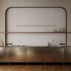 an industrial style kitchen with stainless steel cabinets and counter tops, along with wooden flooring